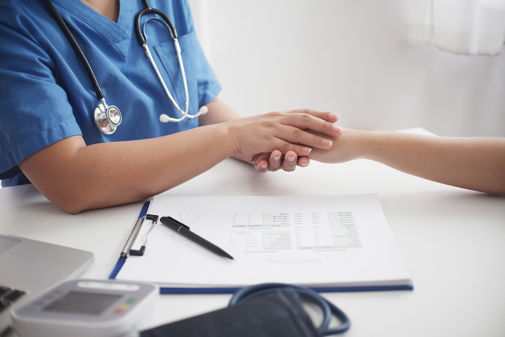 Female medicine doctor working on table with consulting patient